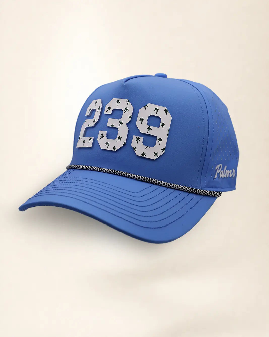 The 239 Signature Hat (Blue), three-quarter view: white raised 239 with small palm print on a blue rope snapback, black and white rope, white Palmr script.