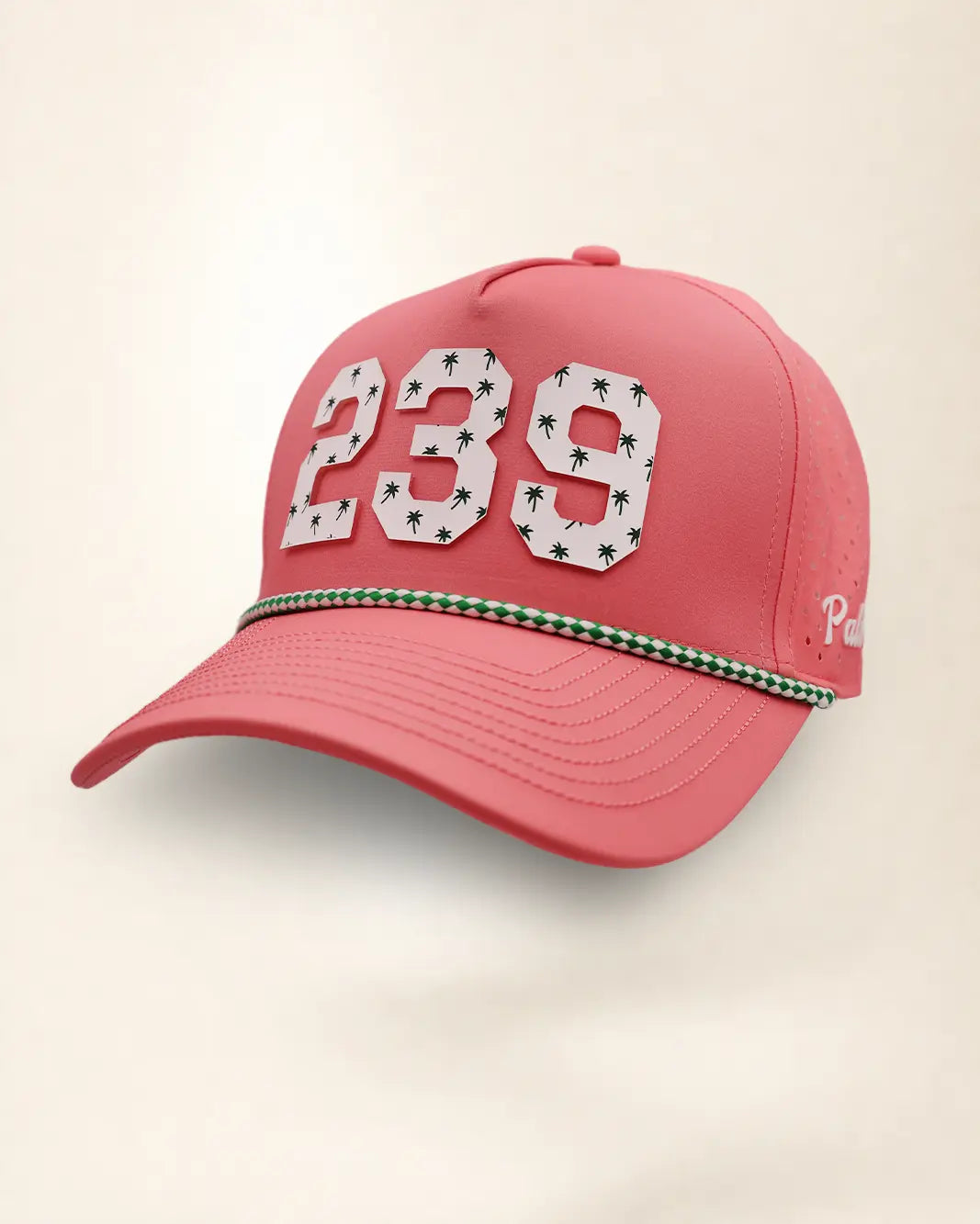 A pink perforated baseball cap showcasing the '239' State with a green and white patterned trim along the brim and white 'Palmr' script embroidery on the side, shown against a light beige background.