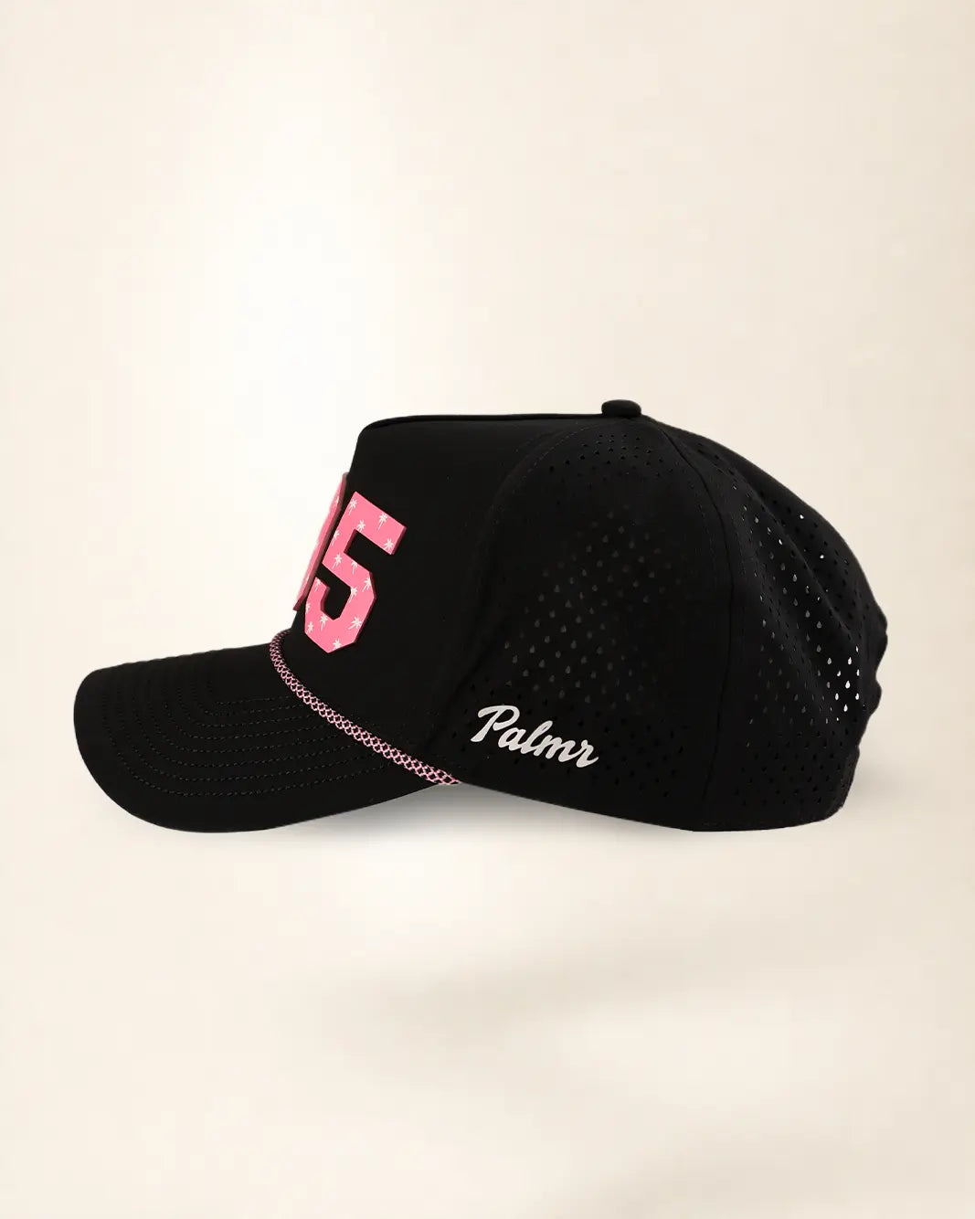 A black mesh baseball cap with a curved brim, featuring a pink embroidered number 5 on the front and the word 'Palmr' in white script on the side, set against a plain off-white background.