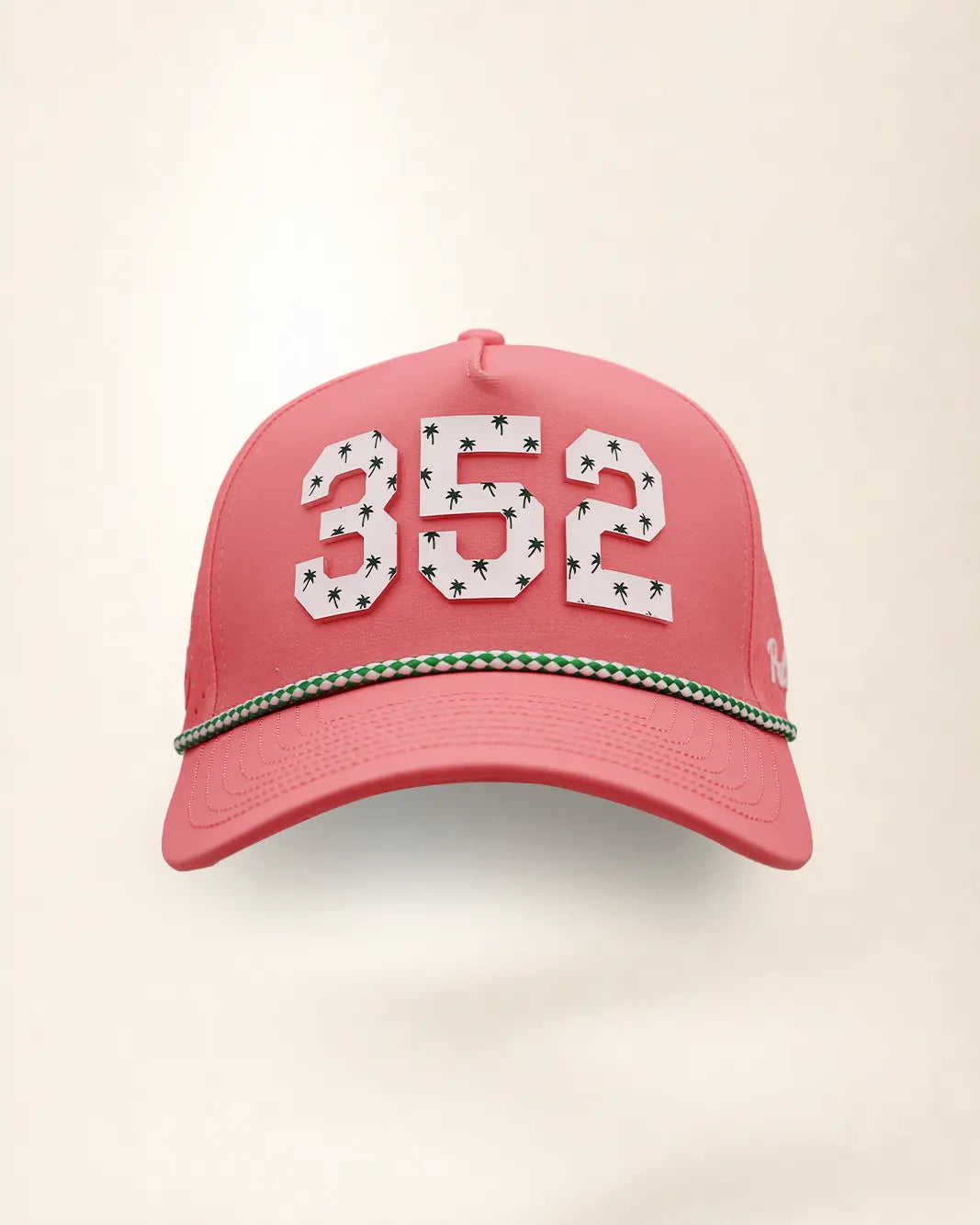 The 352 Signature Hat (Pink), front view: white raised 352 with small palm print on a pink crown, green and white rope along the brim.