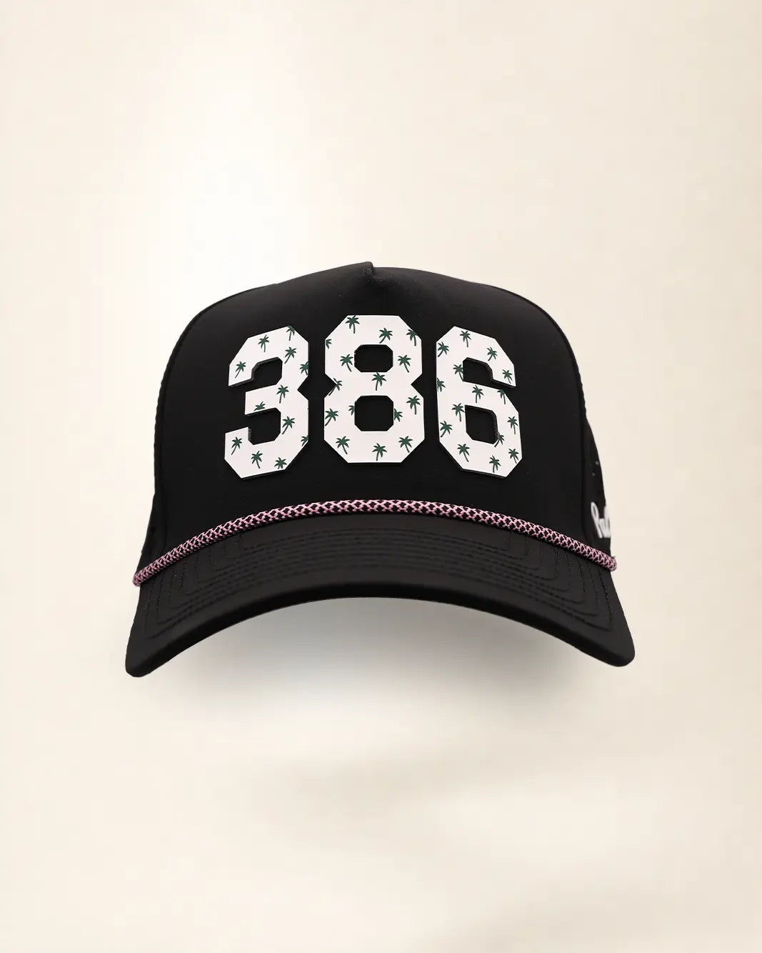 The 386 Signature Hat (Black), front view: white raised 386 with small palm print on a black crown, pink and white rope along the brim.