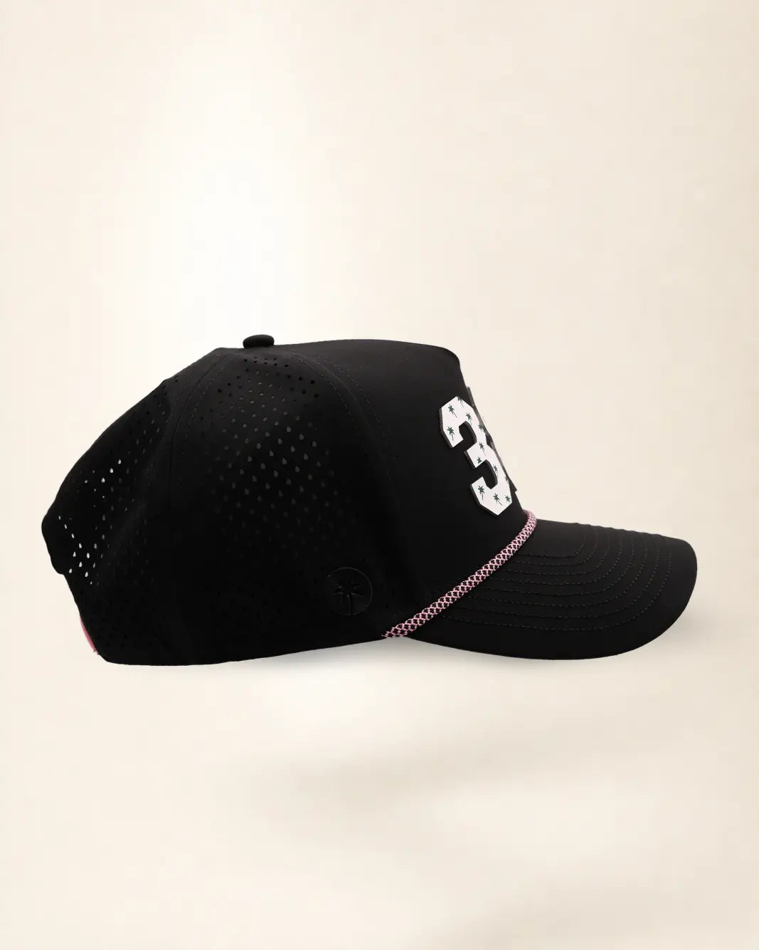 The 386 Signature Hat (Black), right side view: perforated side panel, palm badge, pink and white rope, edge of the white 386.