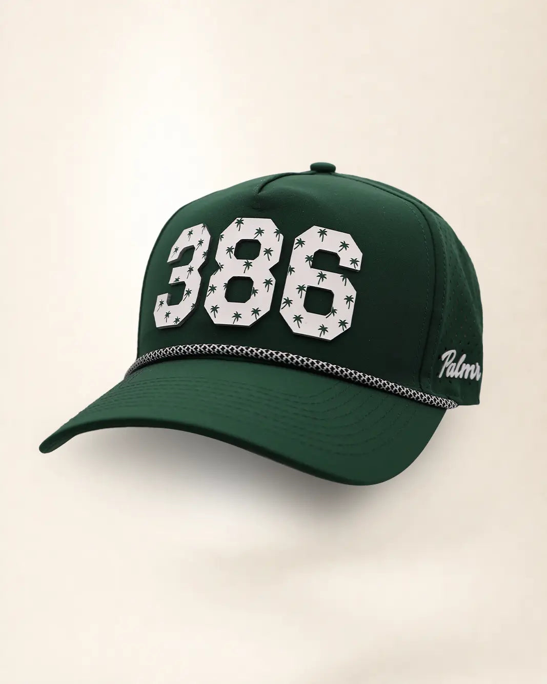 The 386 Signature Hat (Green): dark green rope snapback, white 386 with small green palm trees, black and white braided rope, perforated sides.