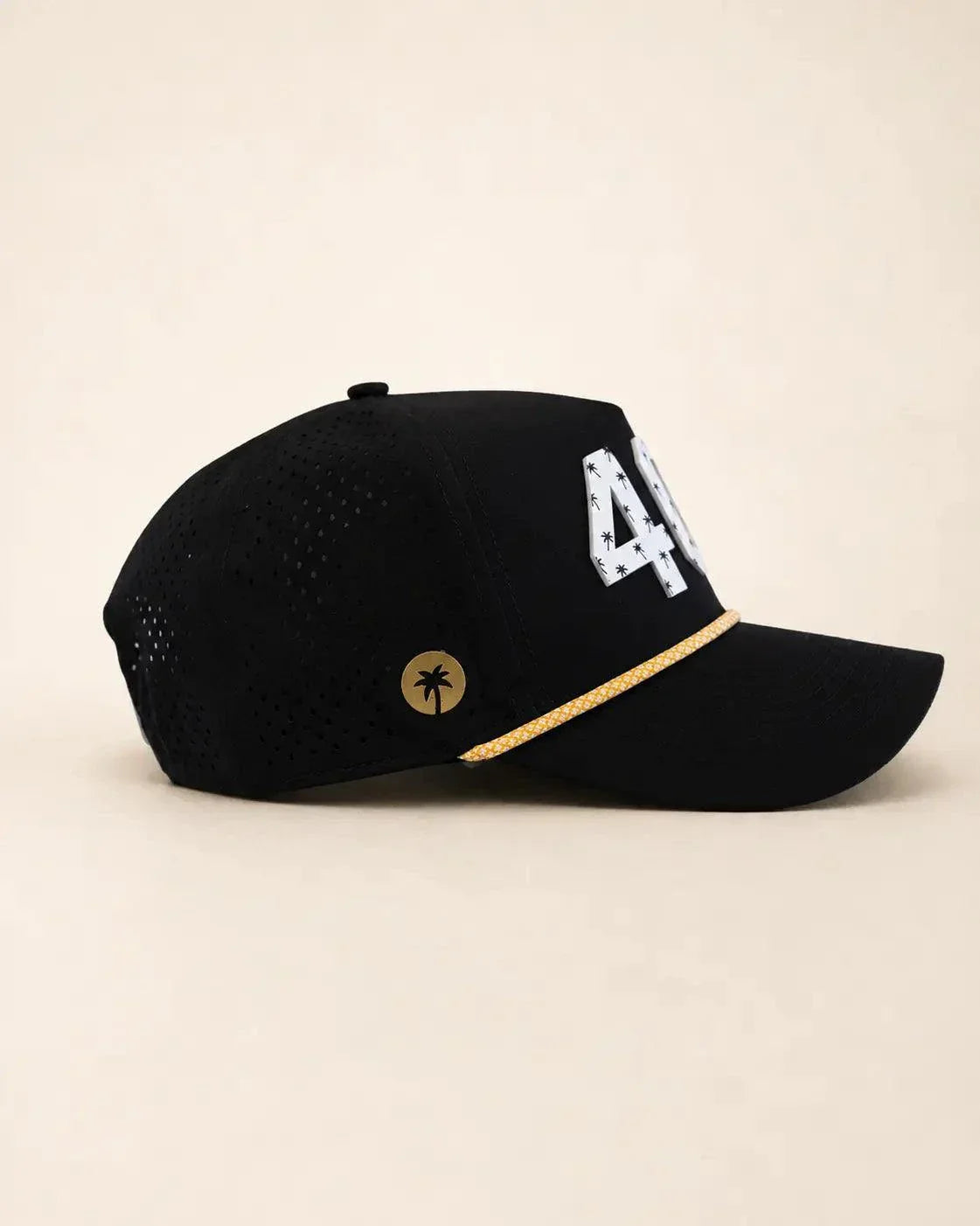 The 407 Hat black and gold with white Orlando area code and gold rope detailing
