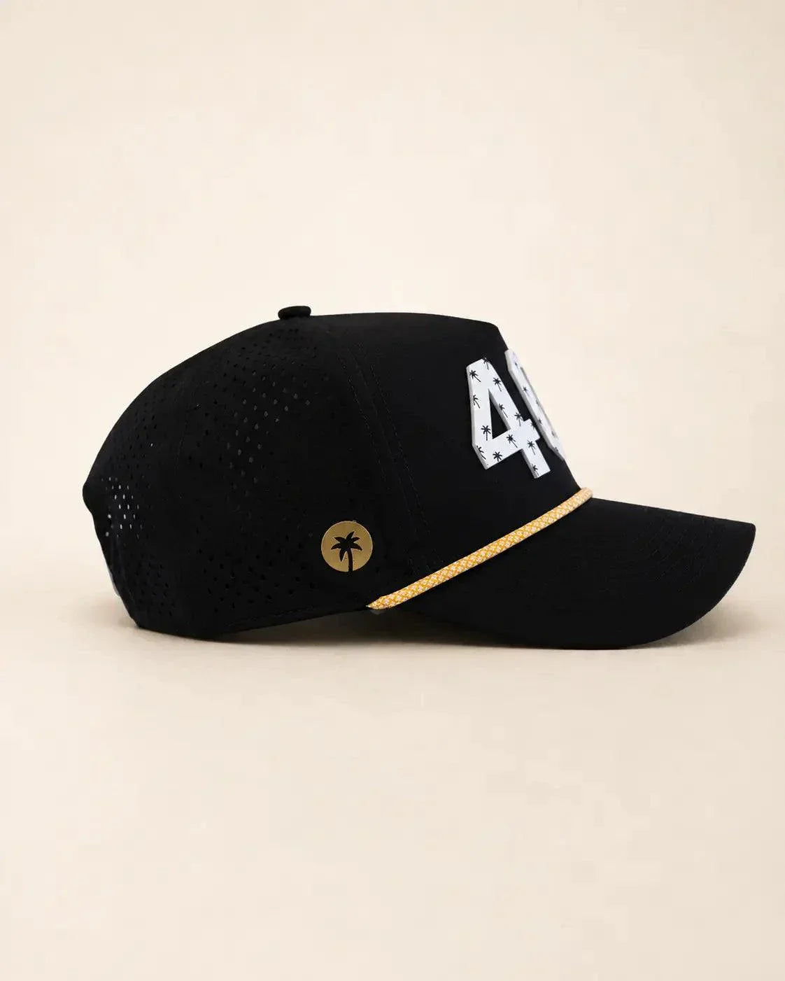 The 407 Hat black and gold with white Orlando area code and gold rope detailing