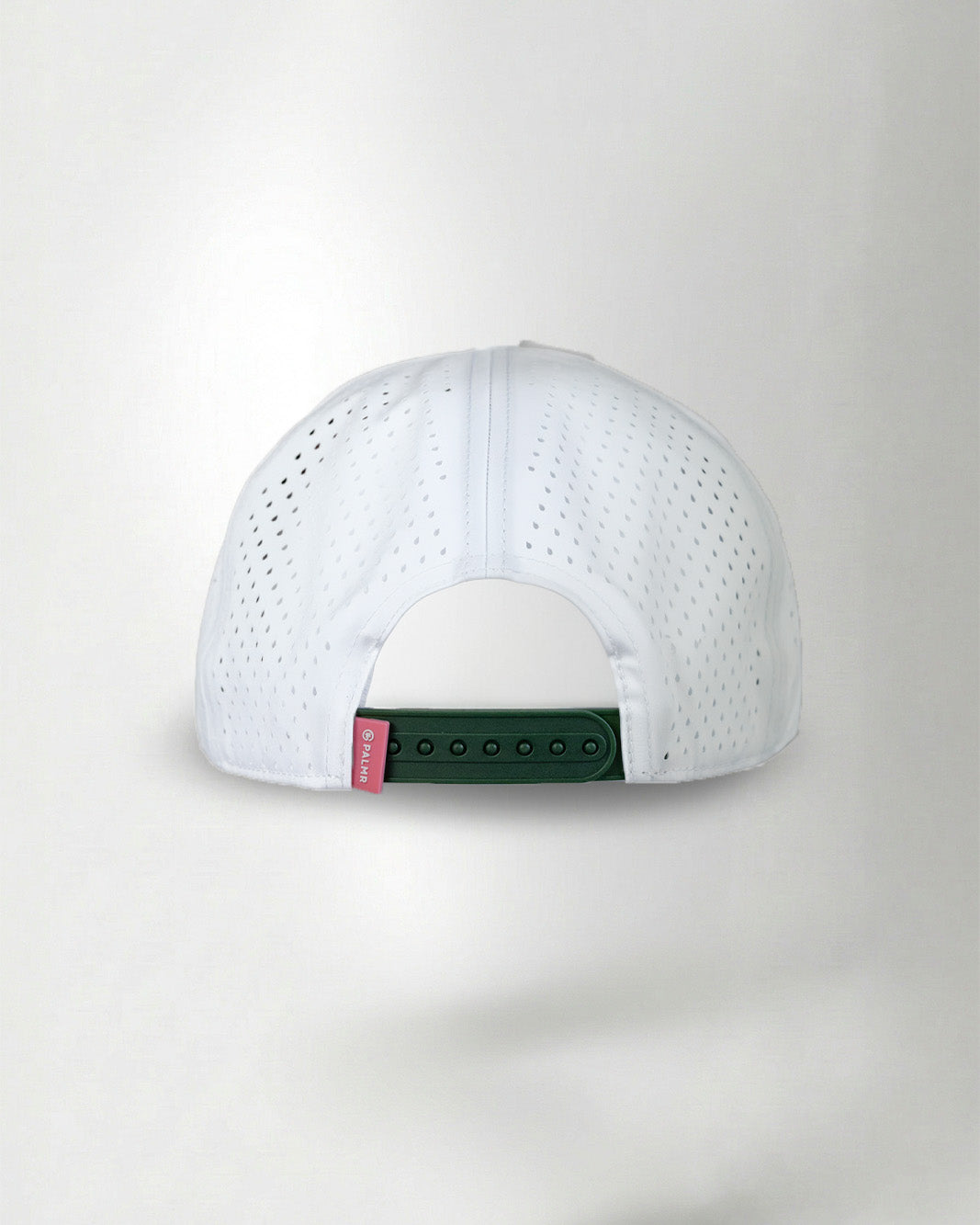 White baseball cap with a red and green tag on a light gray background