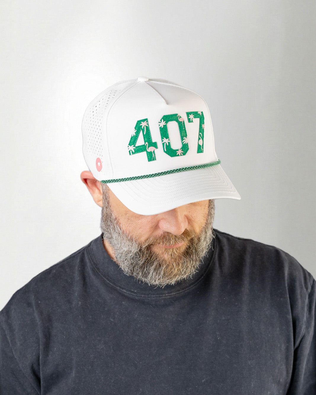 Person wearing a white cap with '407' printed on it against a gray background
