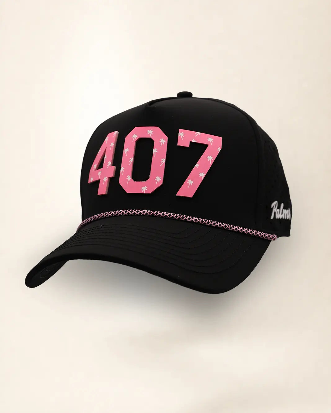 The 407 Signature Hat (Pink on Black), three-quarter view: pink raised 407 with small palm print on a black rope snapback, pink rope, white Palmr script.