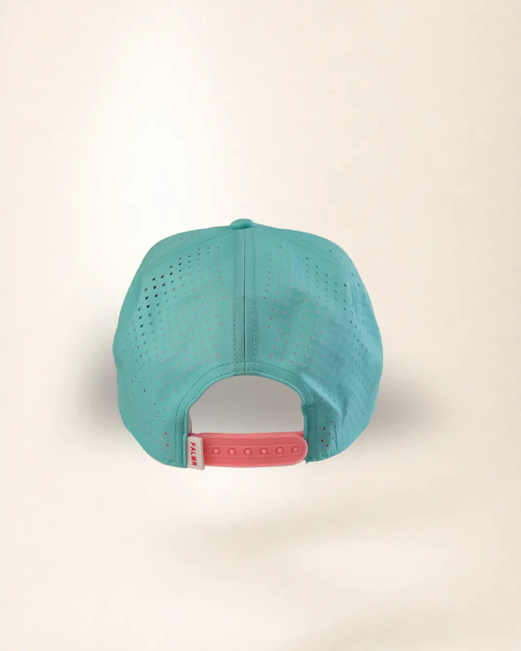 A turquoise blue perforated mesh baseball cap viewed from the back, featuring a pink adjustable snapback strap with a white brand tag.