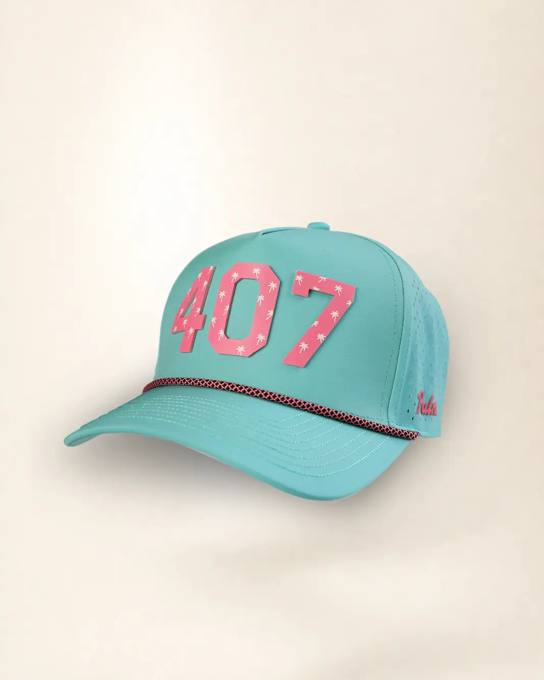 A turquoise baseball cap with '407' in pink star-patterned letters on the front, a thin red and black patterned rope detail across the brim, and a small red script logo on the side, set against a plain beige background.