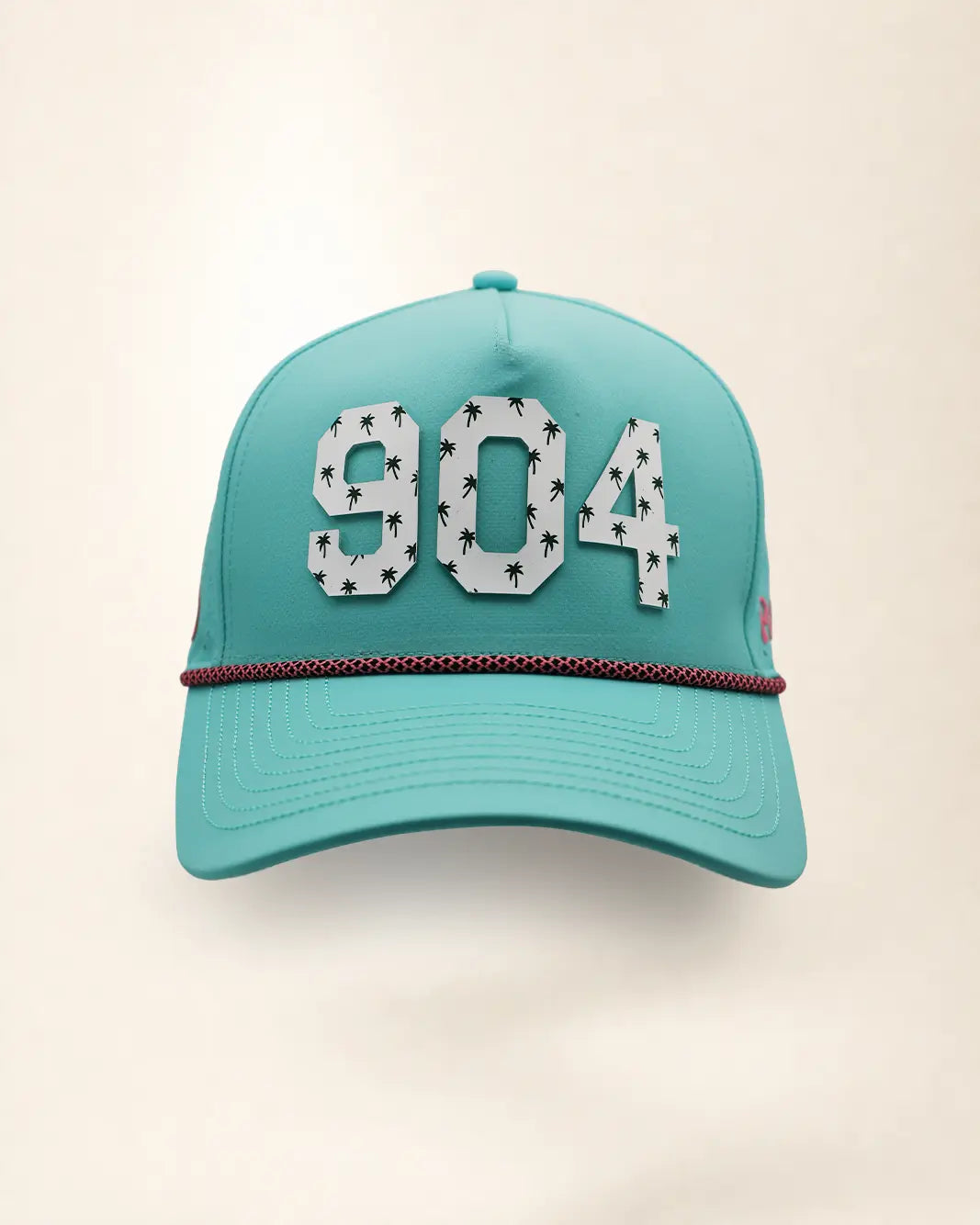 The 904 Signature Hat (Teal), front view: white raised 904 with small palm print on a teal crown, pink and black rope along the brim.
