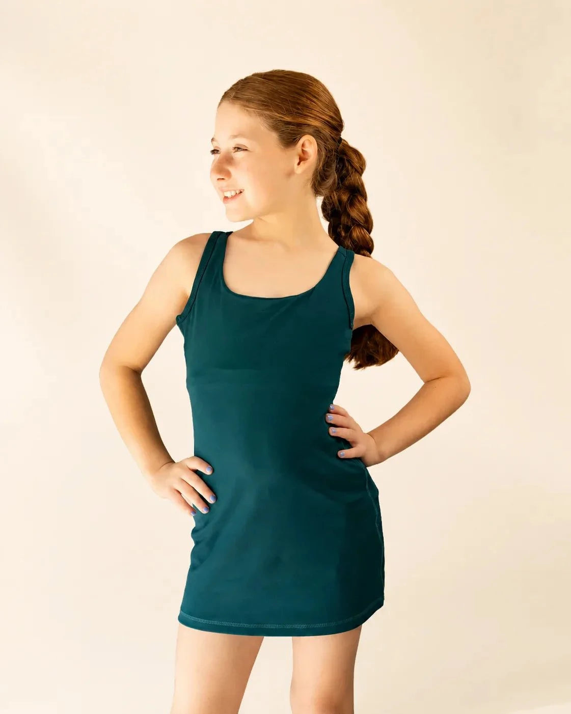 The Ace Kids Dress in palm green with mini palm tree print, pump-friendly shorts, and stretch fabric for active girls