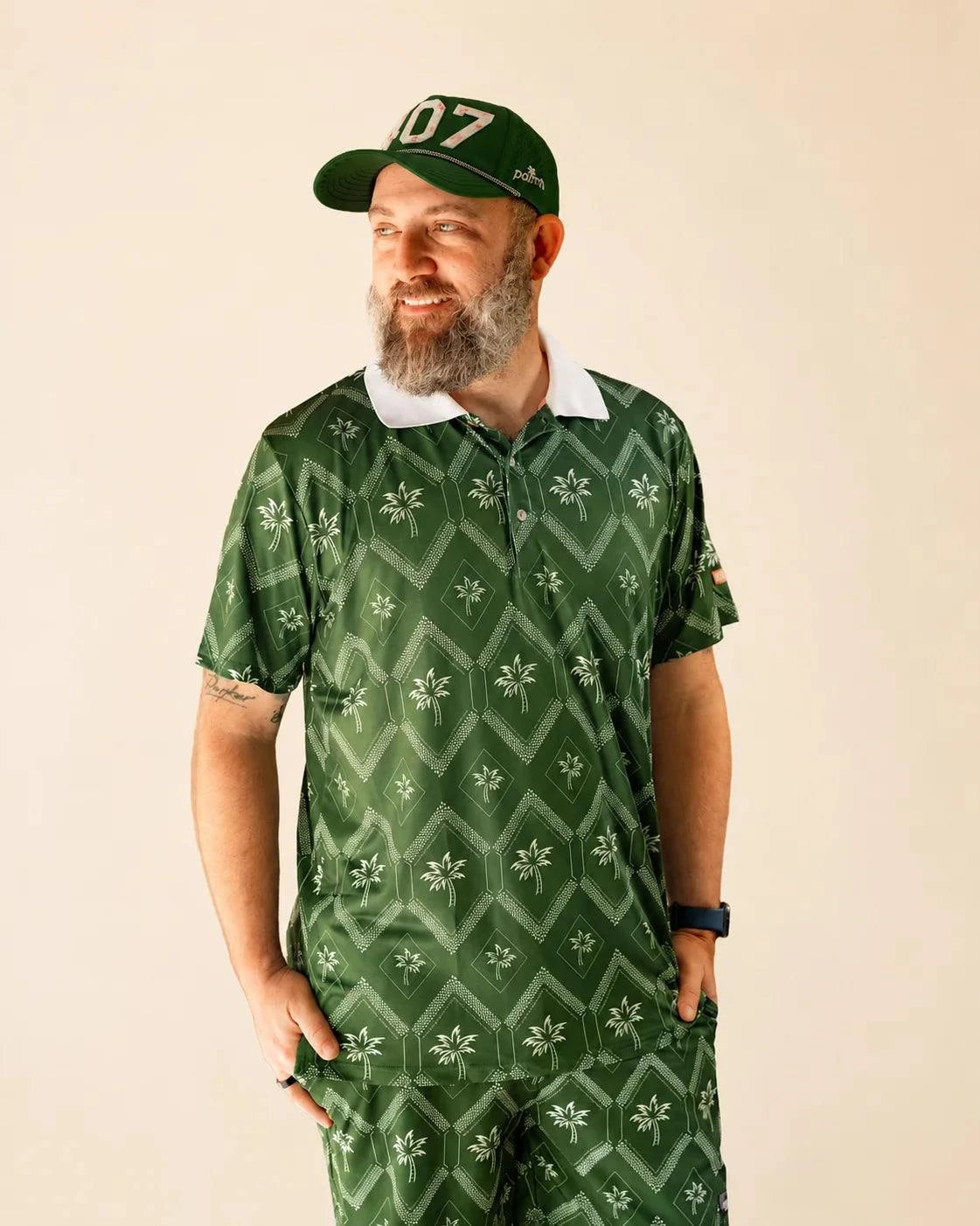 The Club Palm Polo in Palm Green with geometric diamond and palm tree pattern, white ribbed collar, perfect for casual and club wear
