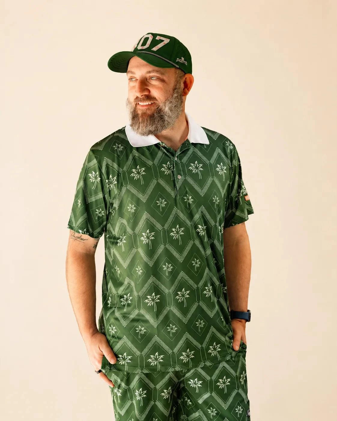 The Club Palm Polo in Palm Green with geometric diamond and palm tree pattern, white ribbed collar, perfect for casual and club wear