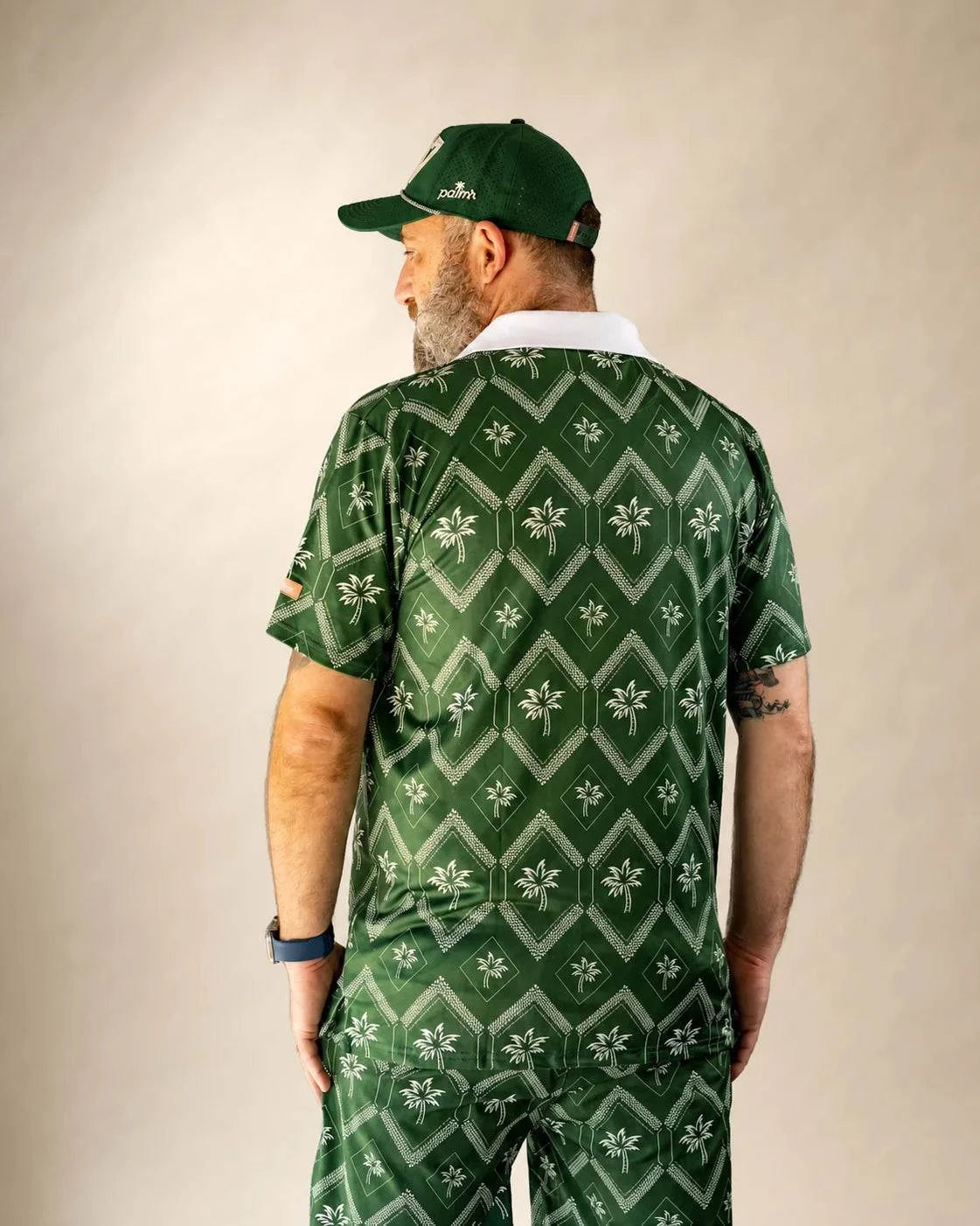 The Club Palm Polo in palm green with geometric diamond pattern and palm tree details, perfect for casual and club wear.