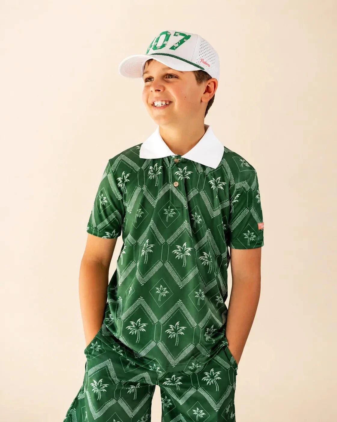 The Club Palm Kids Polo with green geometric palm print and white ribbed collar for active kids