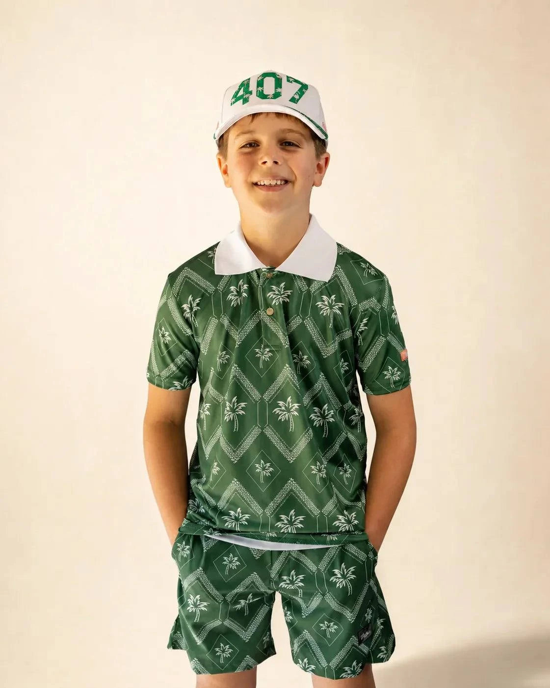 The Club Palm Kids Polo with green geometric palm print and white collar in performance fit for active kids