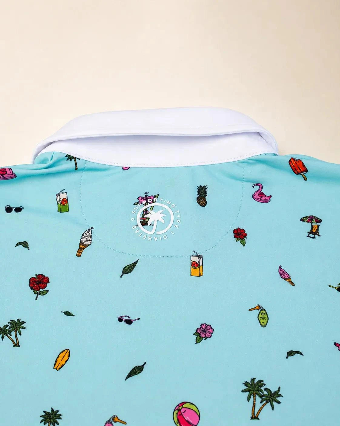 The Palmr Coastal Bay Kids Polo in teal with white collar and palm icons, moisture-wicking and modern fit for active kids