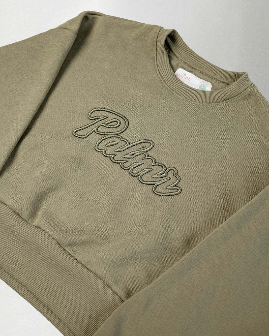 The Palmr Crew Sweatshirt in olive with oversized crop fit and 3D embroidered logo