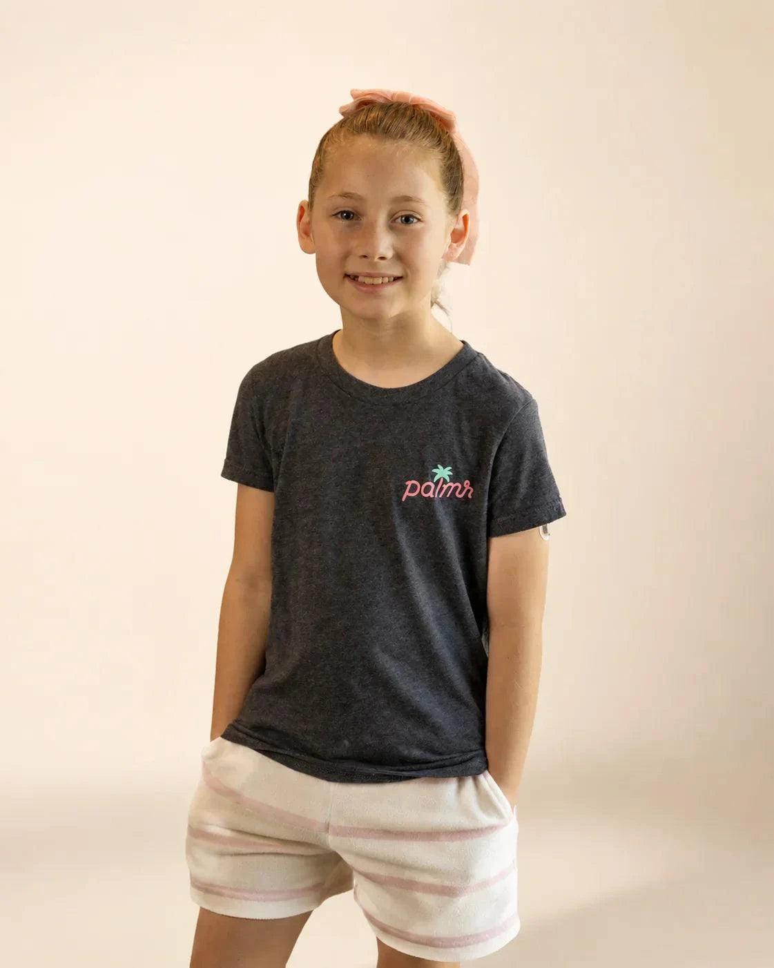 Black mineral wash Evening Palm Kids Tee with Palmr logo and beach-sunset graphic