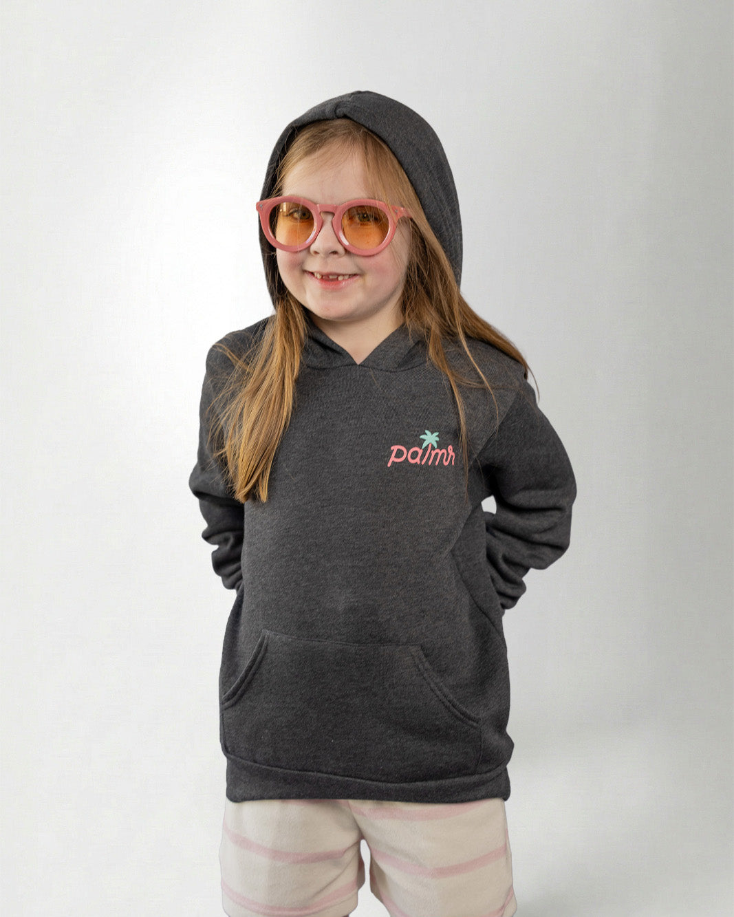 Person wearing a hoodie with a Palmr logo, standing against a plain background.