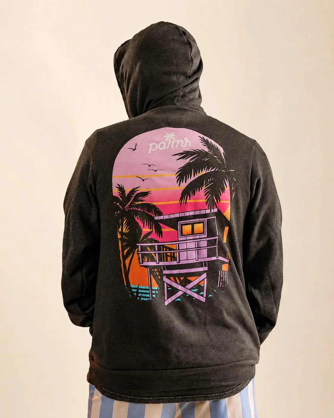 The Evening Palm Hoodie dark heather grey with Palmr logo front and sunset graphic back, lightweight cotton-poly fleece for casual wear