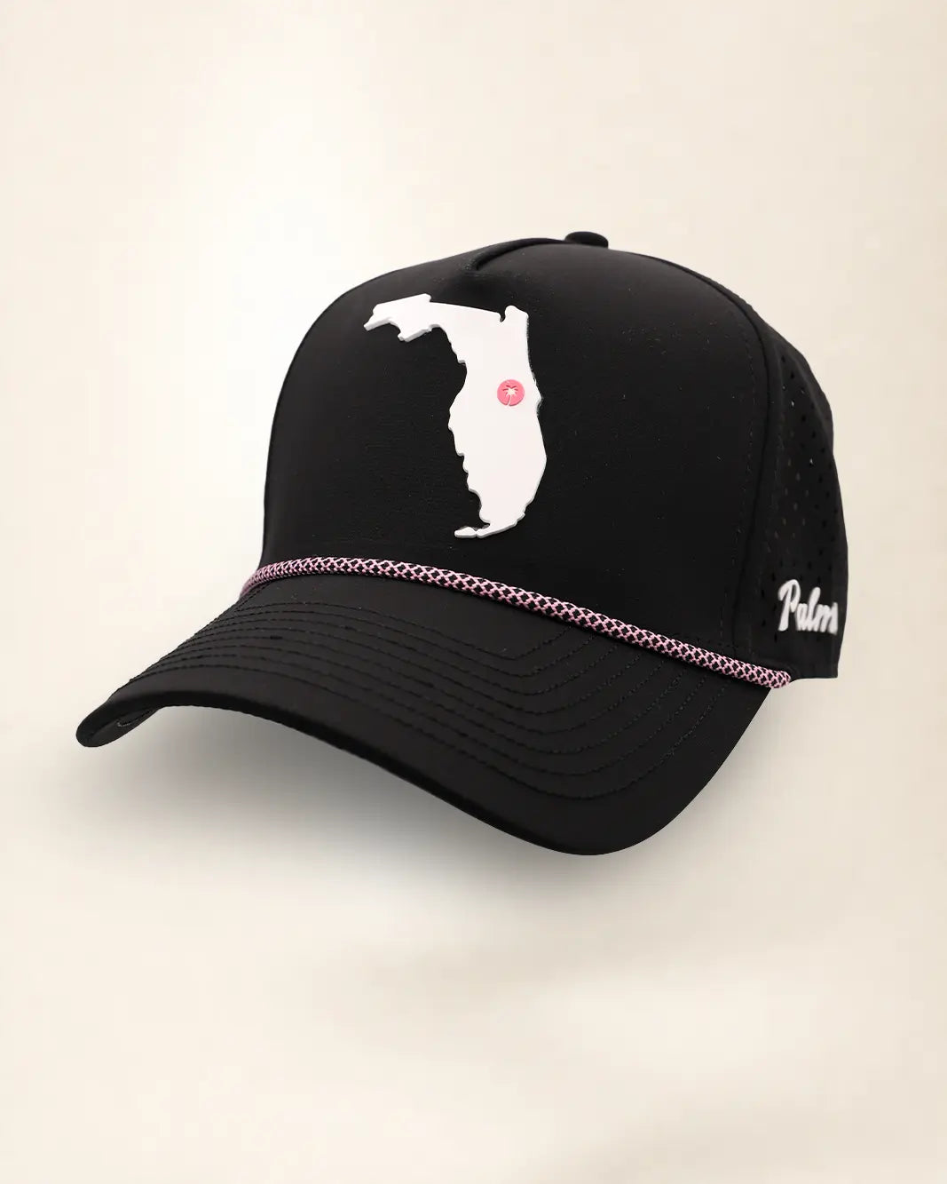 A black baseball cap featuring a white silhouette patch of the state of Florida on the front with a small red dot marking, and a thin metallic rose gold chain trim across the brim.