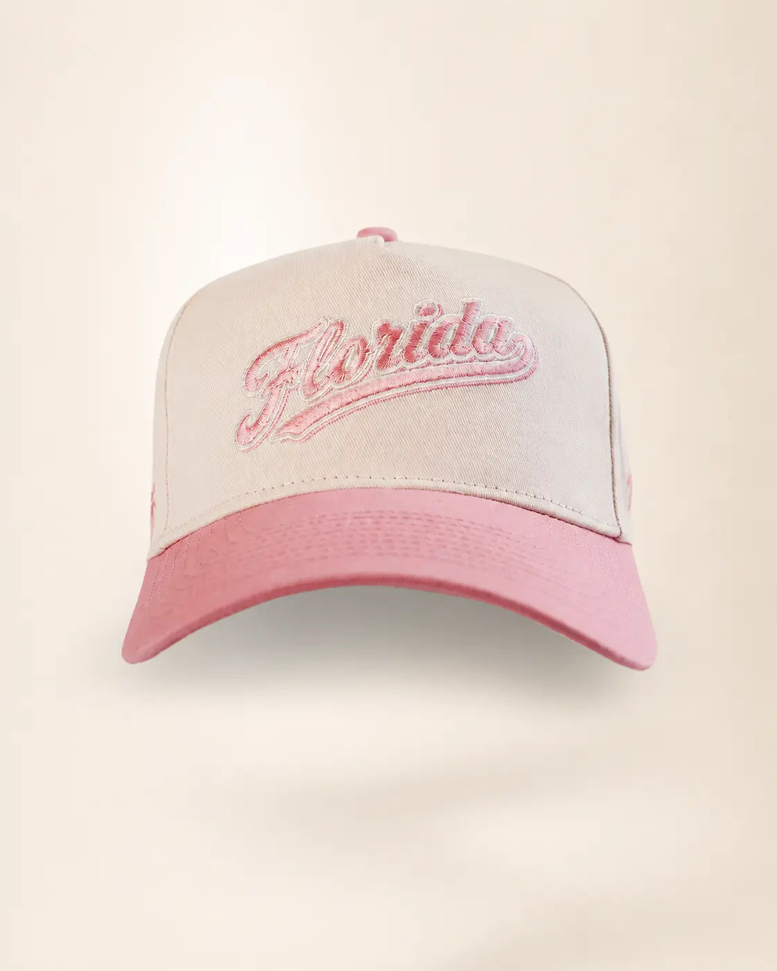 A structured baseball cap with a white crown and a pink brim, featuring the word 'Florida' embroidered in pink script across the front.