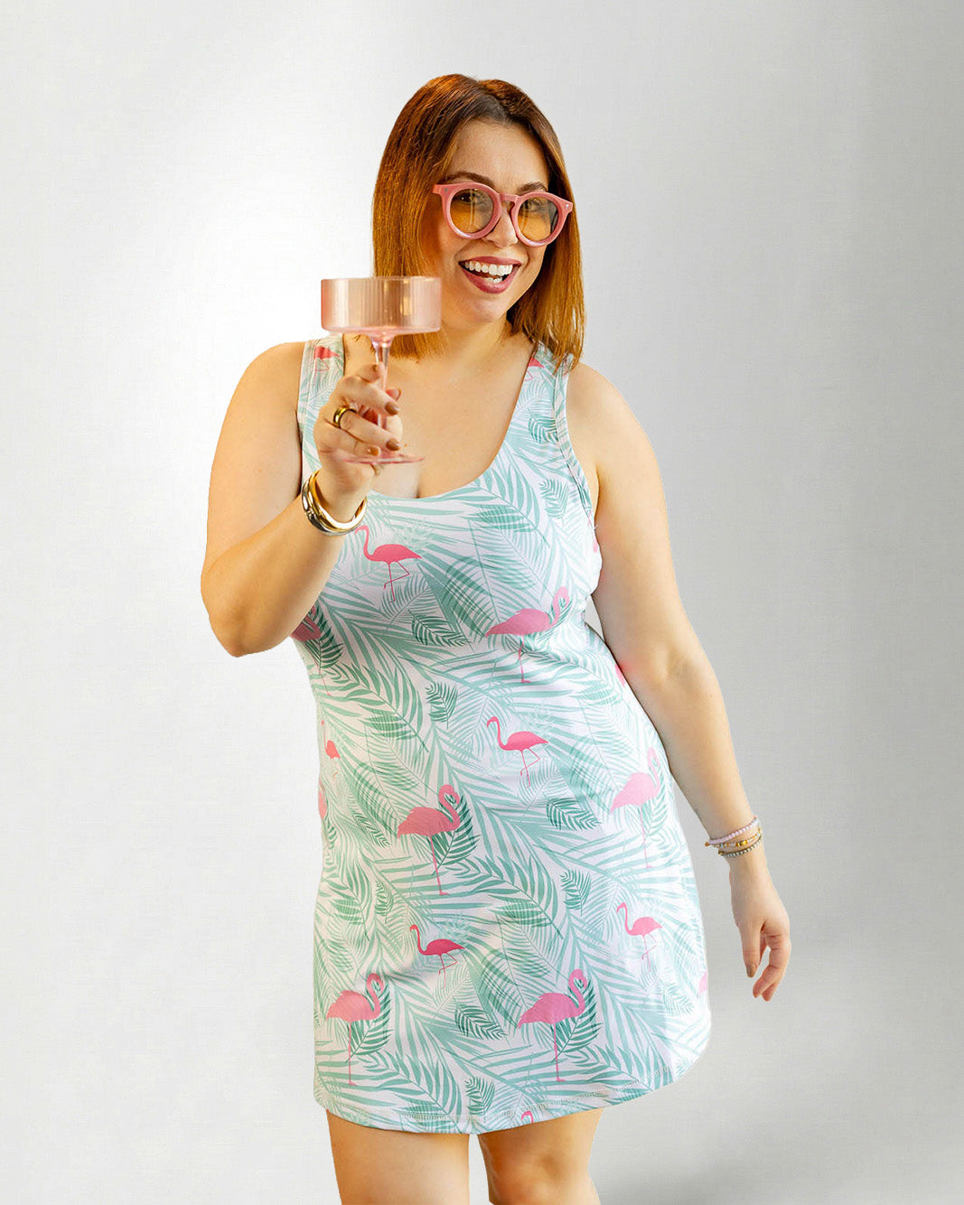 Woman wearing a tropical pattern dress against white background