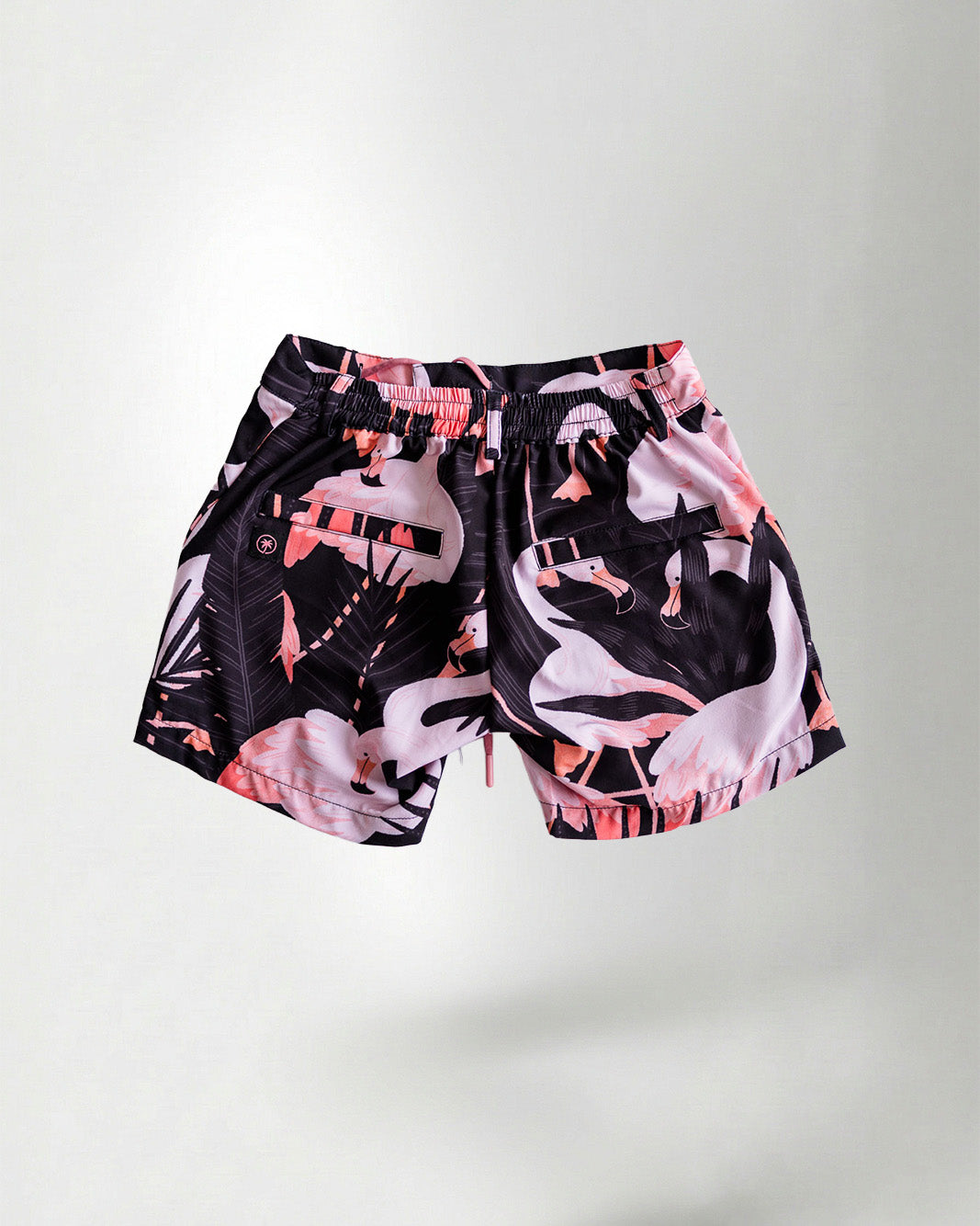 Black patterned shirt and shorts with a white bird design on a plain background