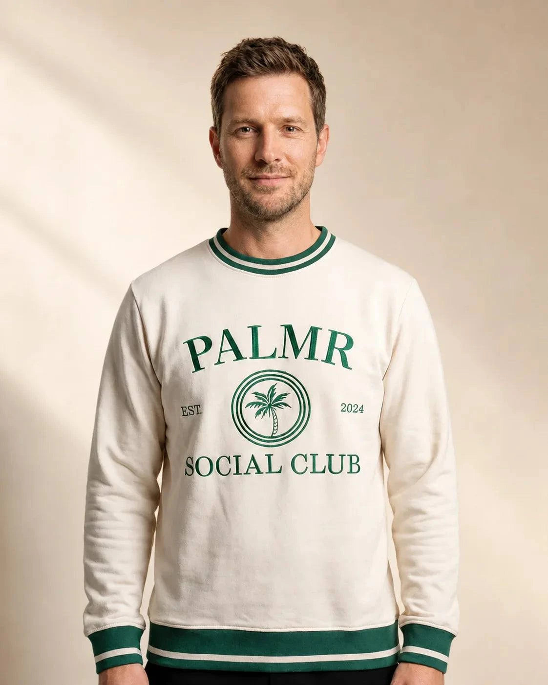 Cream Palmr Social Club varsity sweatshirt with green stripes and embroidered logo