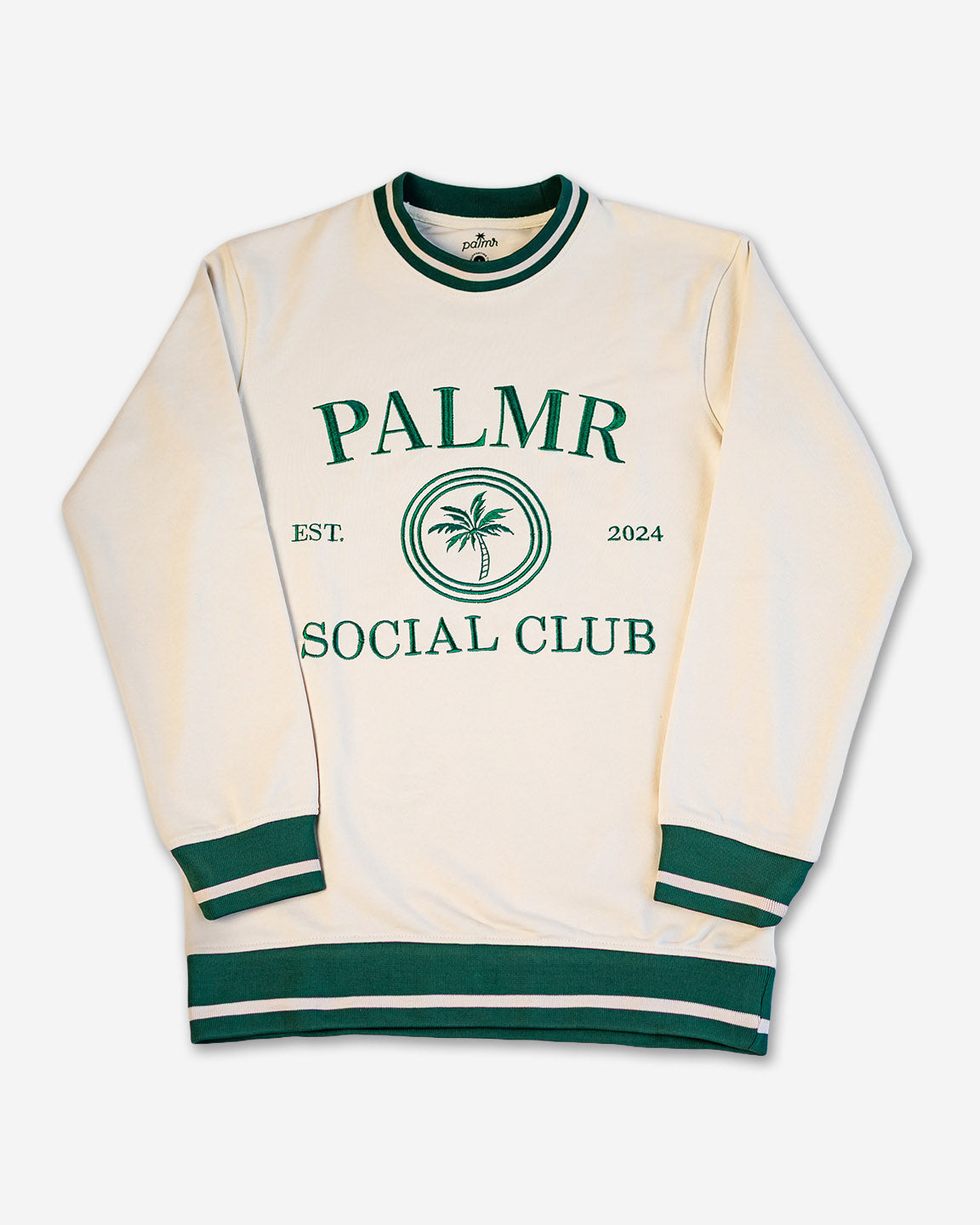 Cream-colored sweatshirt with green accents and 'Palmer Social Club' text on a white background