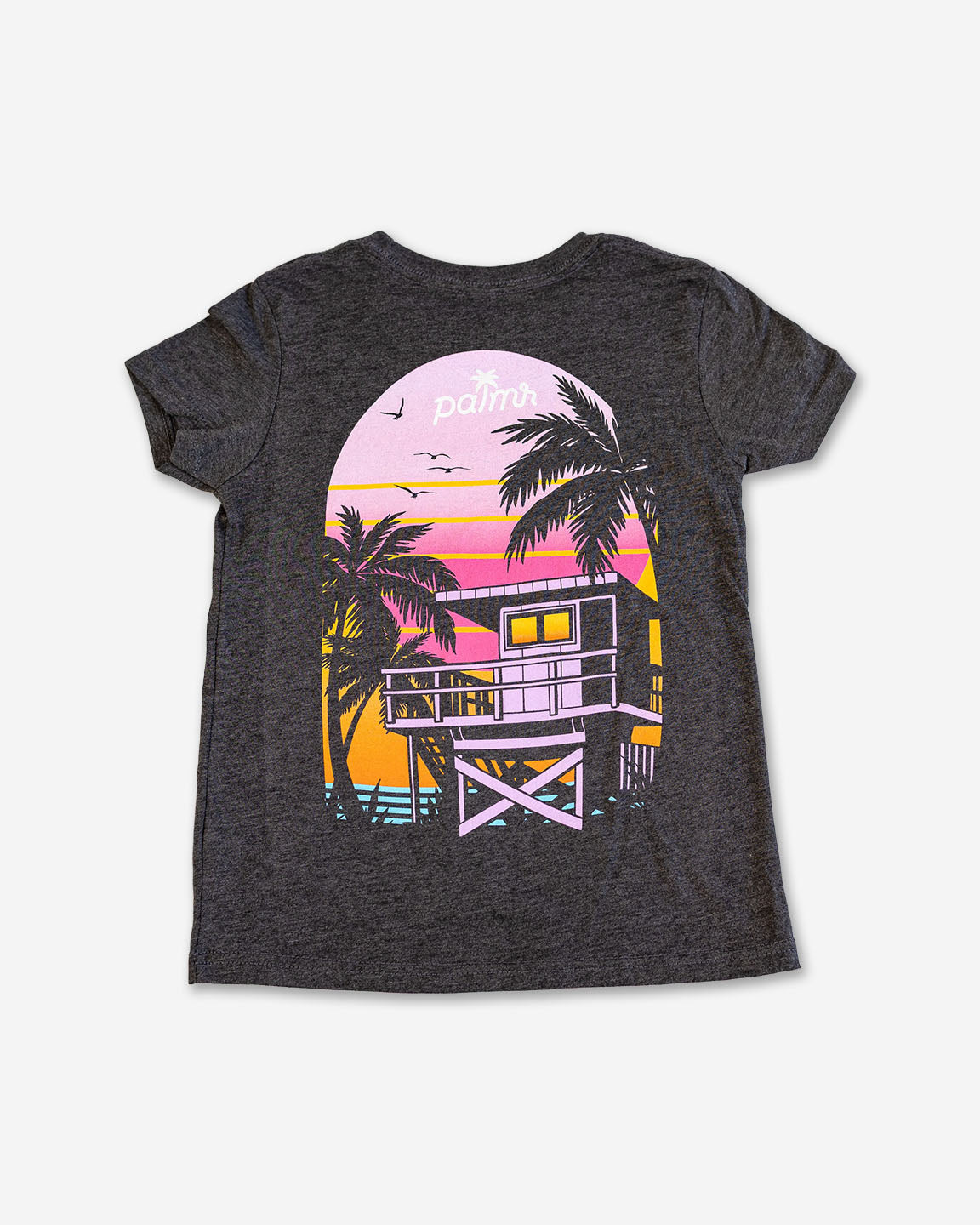 Gray t-shirt with a beach house and palm tree design on a white background