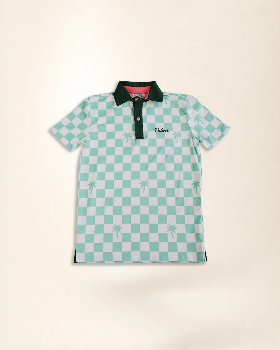 A short-sleeve polo shirt featuring a mint green and white checkered pattern with small palm tree motifs, a dark green collar, and a green embroidered 'Palmr' logo on the chest, displayed flat against a light beige background.