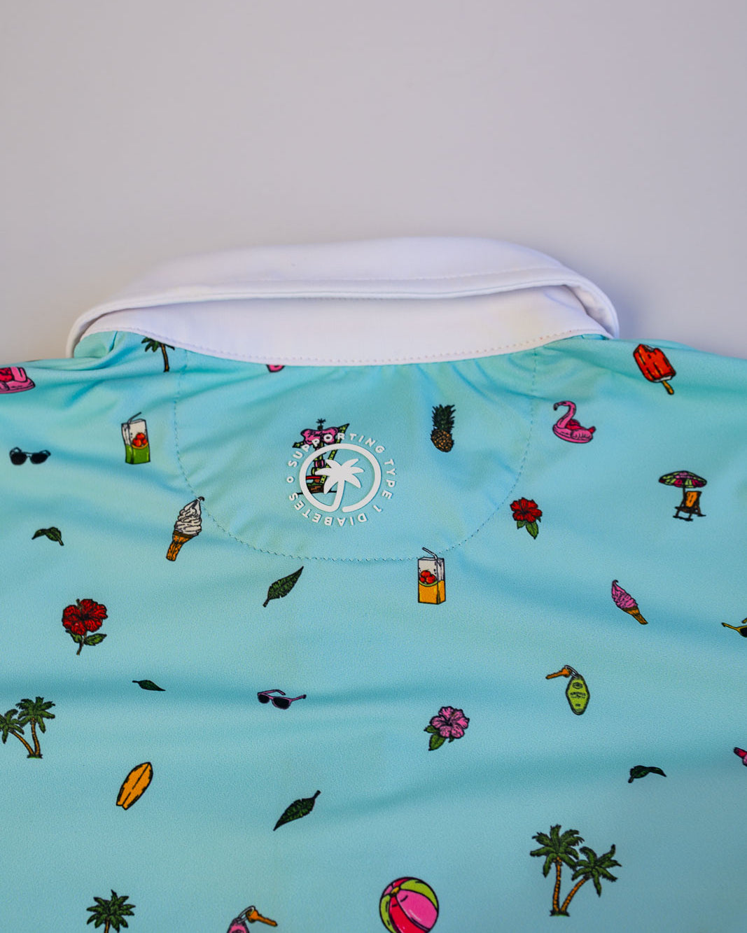 Light blue shirt with colorful patterns on a white background