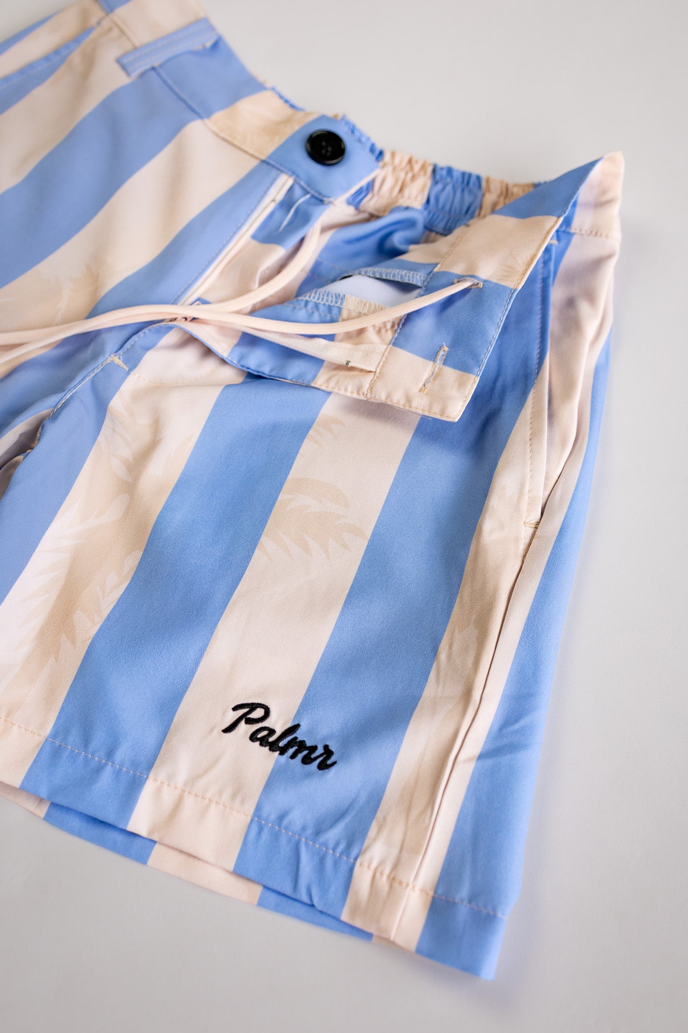Blue and beige striped jacket with 'Palmr' branding on a light gray background