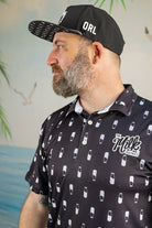 Man wearing a black cap with 'ORL' and a black shirt with white graphics and text.