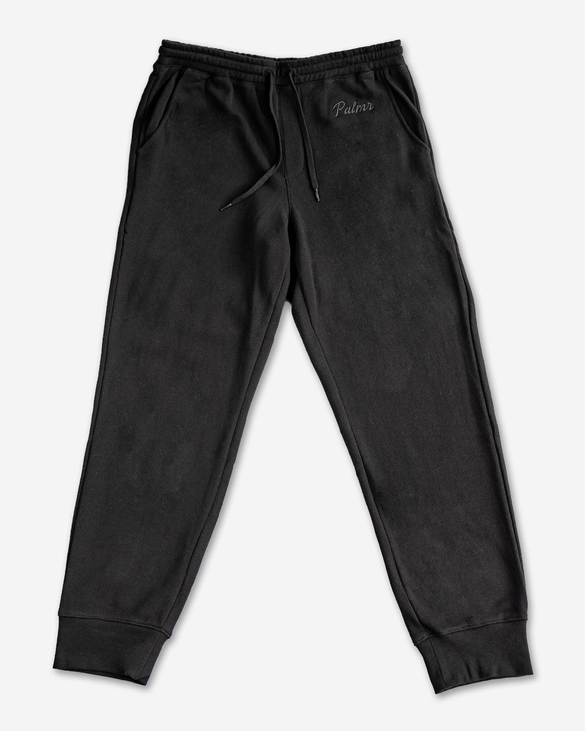 Black sweatpants with a brand logo on a white background