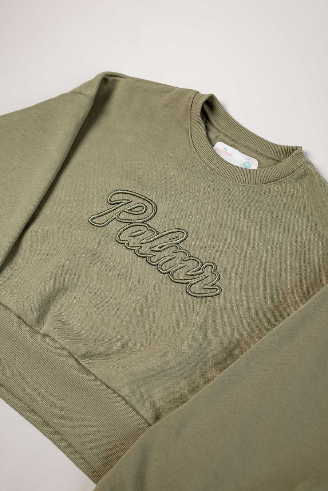 Olive green sweatshirt with 'Palmr' embroidery on a light gray background