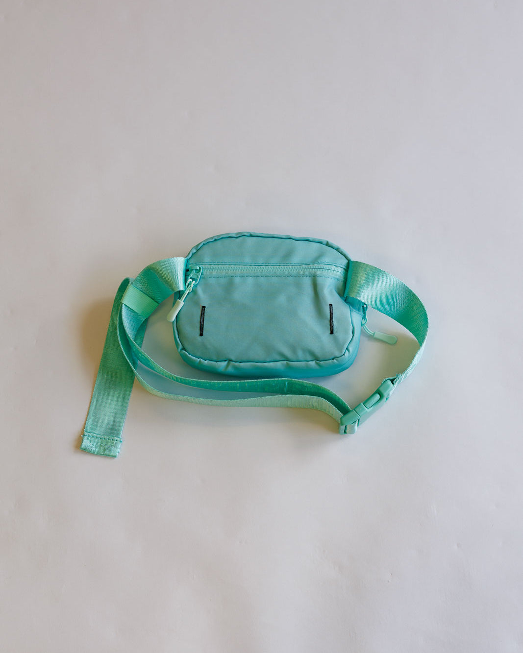 Green waist bag on a light gray background