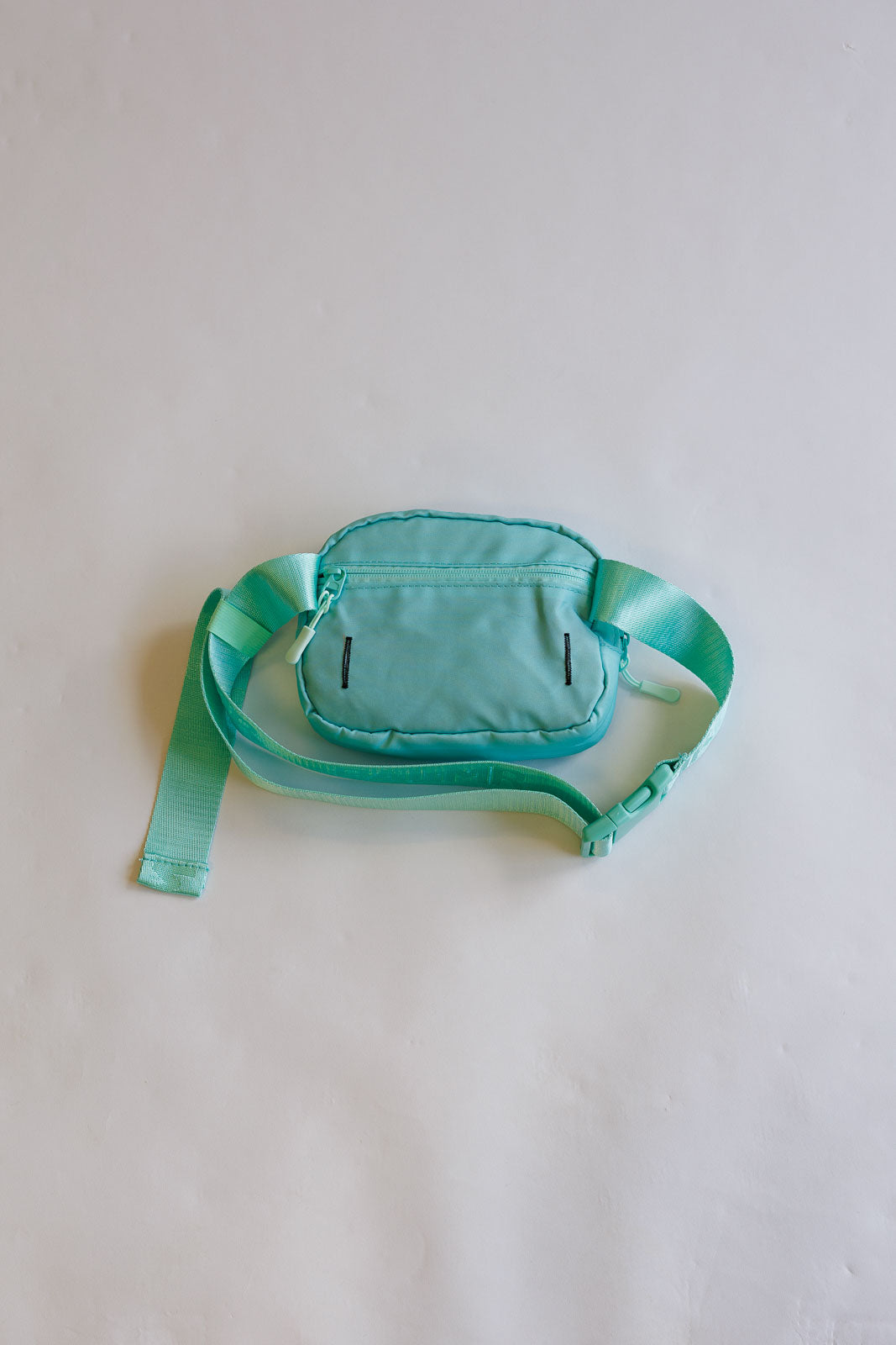 Green waist bag on a light gray background
