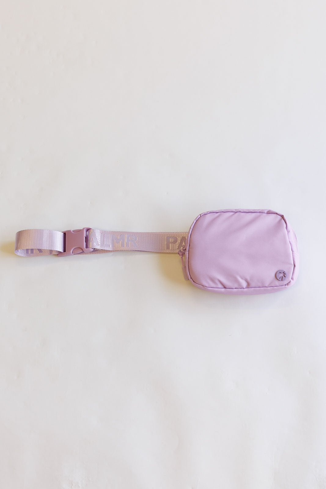 Purple waist bag with a belt on a white background
