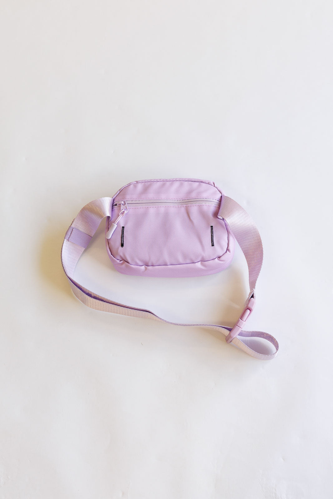 Pink waist bag on a light beige background