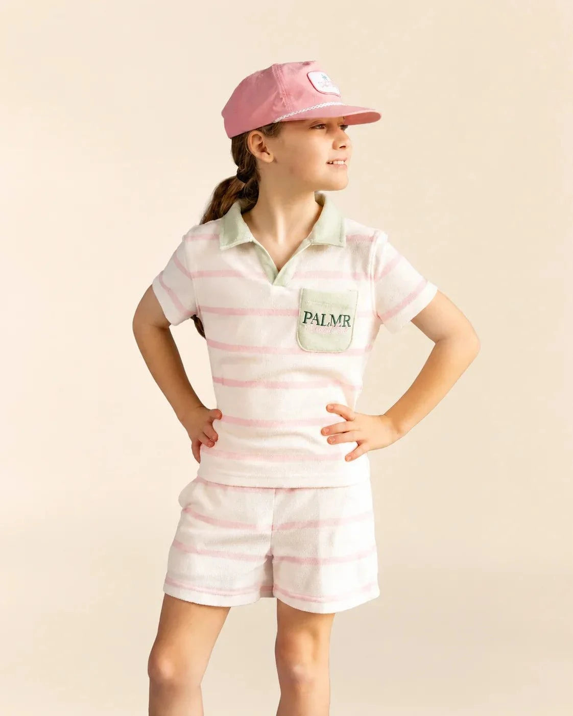 Girl's cabana pink stripe top with green collar and pocket on child