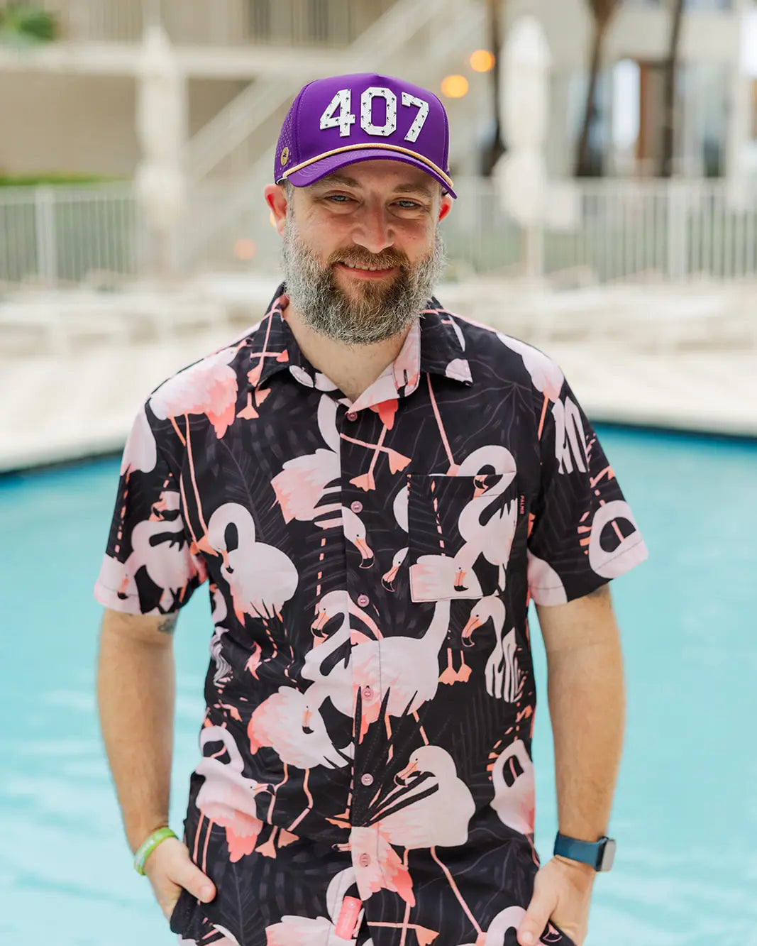 Man wearing the Purple and gold The 407 Hat with white Orlando area code and small palm logo on side