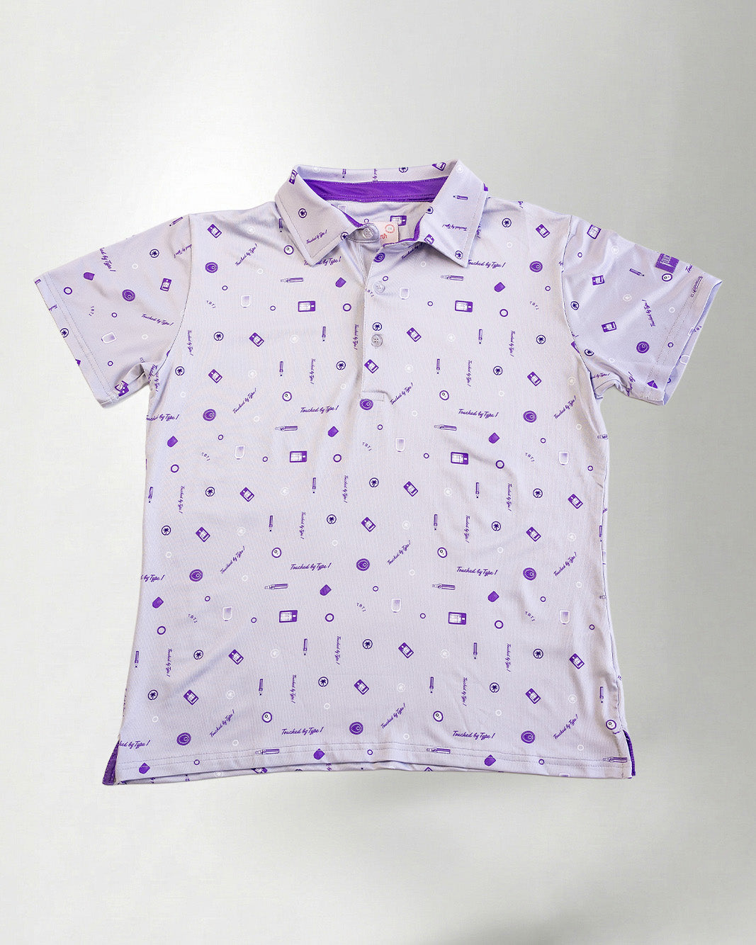 Woman wearing a patterned shirt and jeans against a plain background