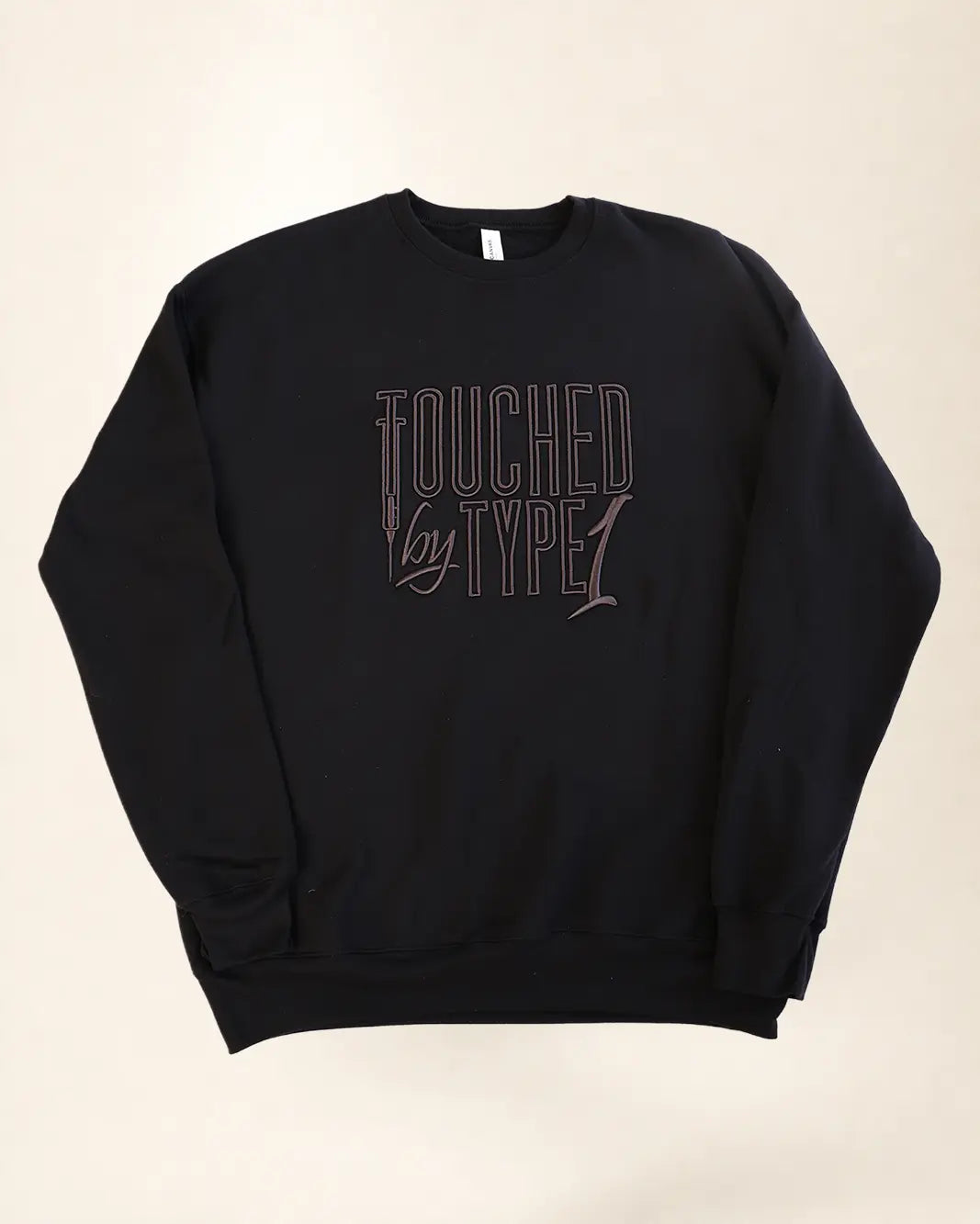 Black sweatshirt with 3d stylized embroidery lettering that says 'Touched By Type 1'