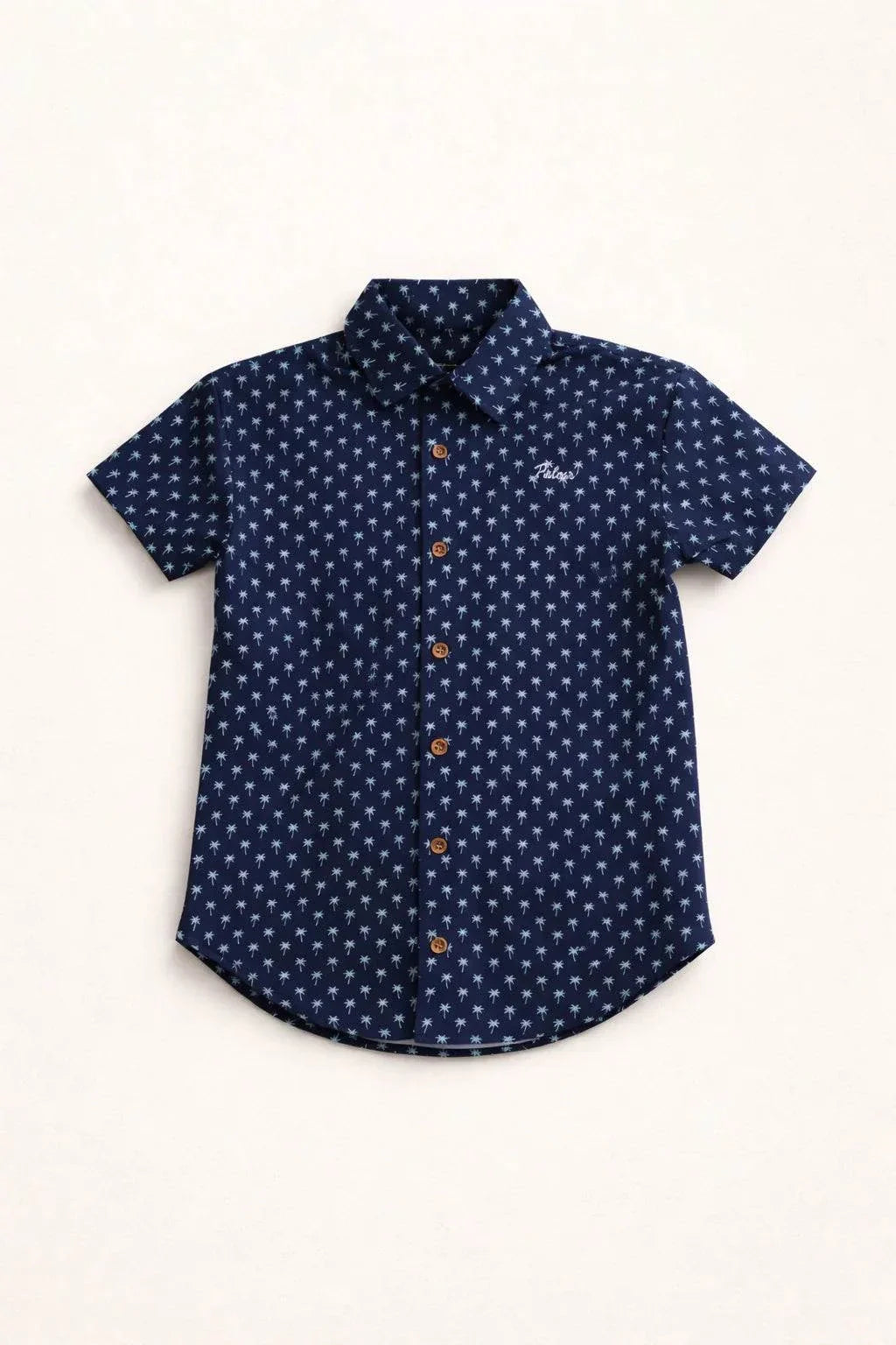 Boy wearing Indigo Palm Kids Button Up navy micro-print shirt with embroidered Palmr script