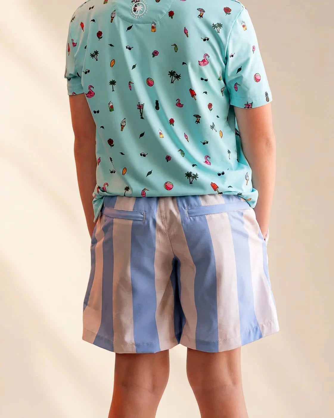 Kids wearing blue and tan striped Ronnie Kids Hybrid Swim Shorts by the water