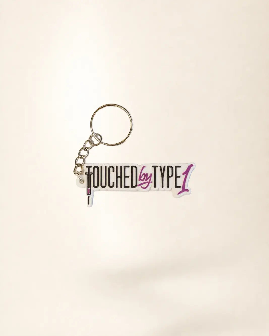 Keychain with 'Touched by Type 1' text on a light background